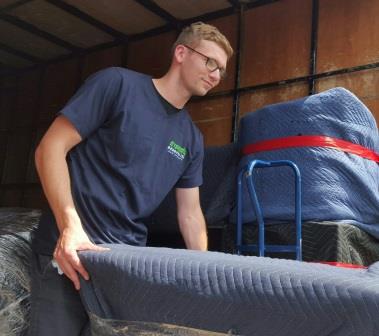 removalist unloading carpet and furniture
